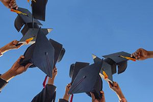 Law students throwing their graduation caps in the air.